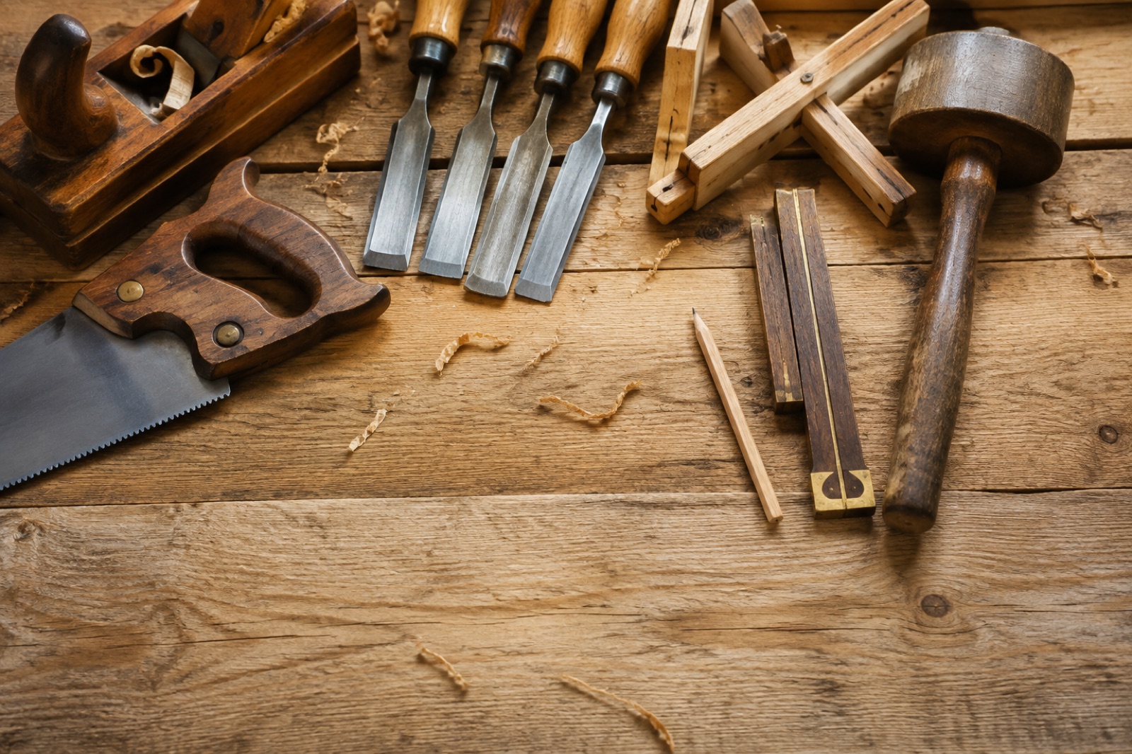 Woodworking tools arranged beside timber